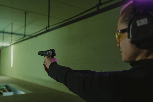 Woman at indoor range practicing her pistol shooing.