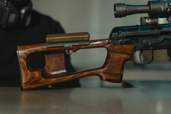 Rifle sitting on table at shooting range.